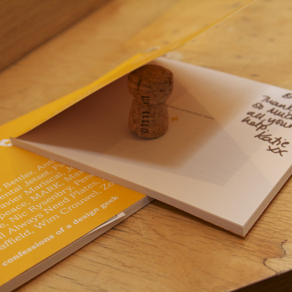 Book with dedication propped open with champagne cork